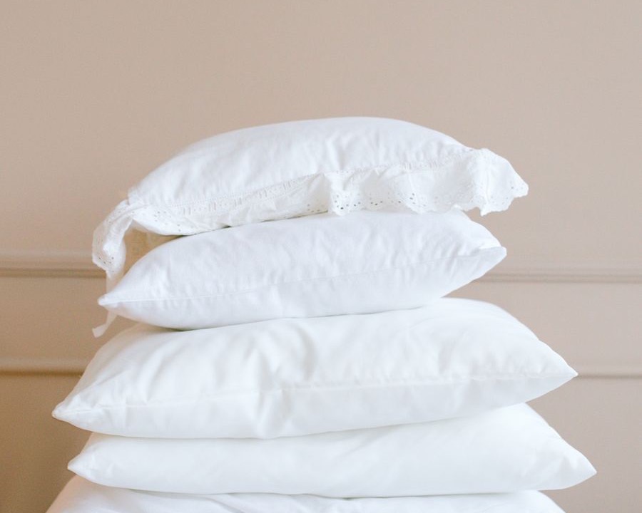 A stack of crisp white pillows and folded linens