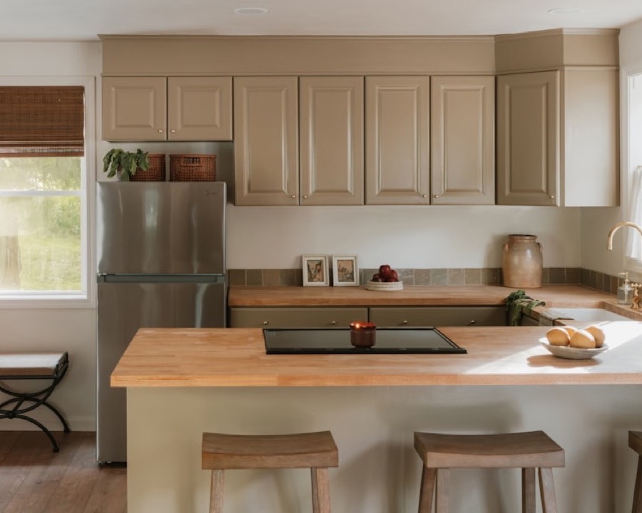 A warm, tidy kitchen with a butcher-block island