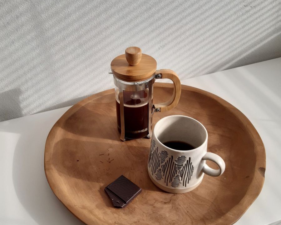 A morning coffee tray with a French press and mug